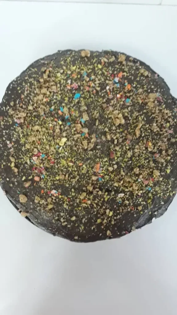 Chocolate cake with a diameter of 25cm, topped with nuts and truffles.